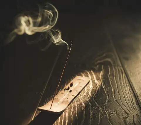 Pooja items: white smoke on black surface