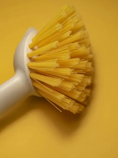 Toilet & basin brushes: A yellow scrub brush on a yellow background