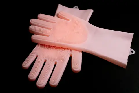 Gloves: a pair of pink gloves sitting on top of each other