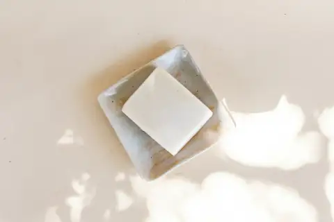 Bathroom accessories: white square container on white table