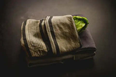 Roti rumal & napkins: a towel with a green leaf on top of it