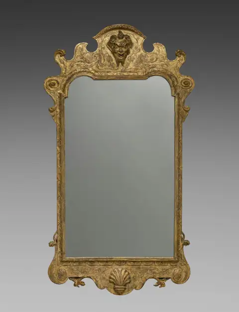 Mirrors: Ornate gilded mirror with carved decorative elements