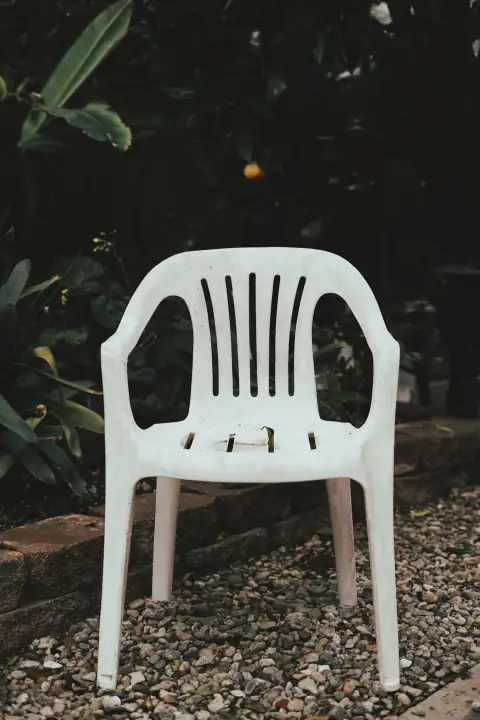 Stools & chairs: white plastic chair on brown soil