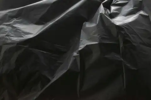 Garbage bags: a close up of a black plastic bag