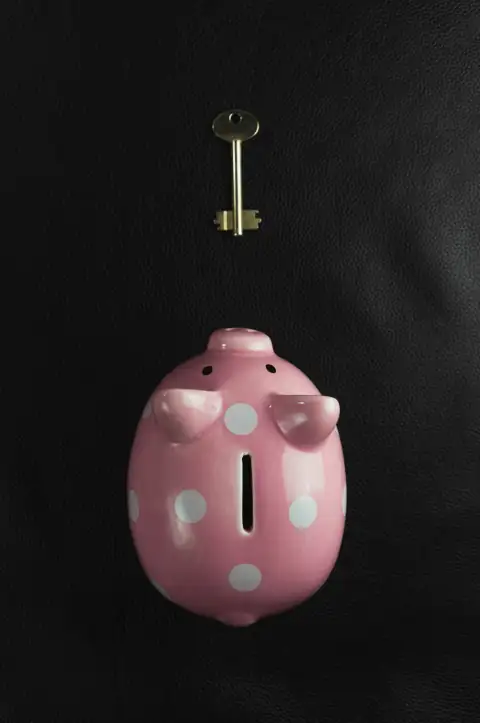 Piggy banks: a pink piggy bank with a key hanging from it