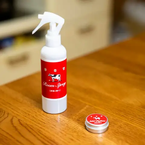Air fresheners: White spray bottle and small tin on wooden table